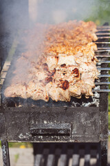 Cooking meat skewers on skewers on the grill