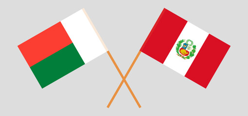 Crossed flags of Madagascar and Peru. Official colors. Correct proportion