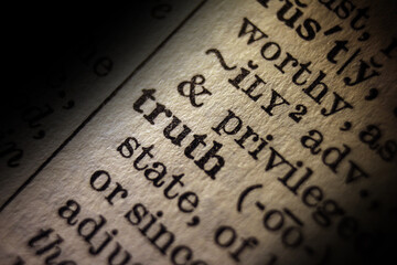 Word "truth" printed on book page, macro close-up