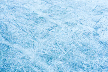 Ice texture, ice cracks and stripes after skating, natural winter background