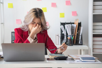 Concept Burnout Syndrome. Asian business Woman feels uncomfortable working. Which is caused by...