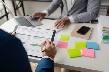 Meeting room atmosphere, business people meeting together on finance topics, they are working together to plan and solve corporate finance issues. Concept of business administration and finance.