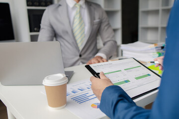 Meeting room atmosphere, business people meeting together on finance topics, they are working together to plan and solve corporate finance issues. Concept of business administration and finance.