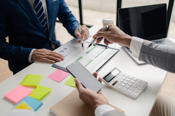 Meeting room atmosphere, business people meeting together on finance topics, they are working together to plan and solve corporate finance issues. Concept of business administration and finance.