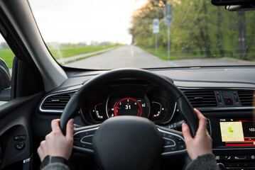 First person view of driving a car on countryside roads. First person view of sitting in a modern...