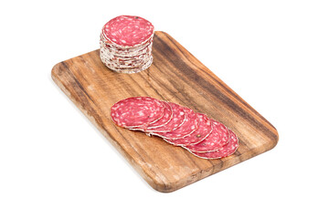 Slices of salami on wooden board