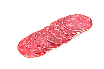 Slices of salami sausage on a white background