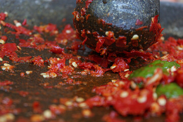 Sambal or traditional chili sauce from Indonesia, freshly made using stone mortar and pestle. Made...