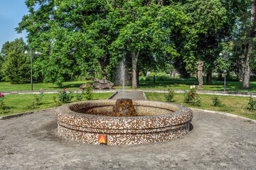 Fountain in the city garden near the Manor of Koenig in Trostyanets, Sumy Oblast, Ukraine. Summer landscape in the park
