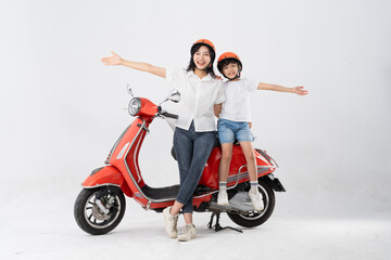 mother and son wearing helmets and riding motorbikes
