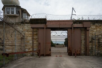 an entrance to a large building that has bars on top of it