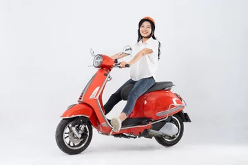 Foto op Plexiglas full body photo of a woman wearing a hairdresser and driving a motorbike © 1112000
