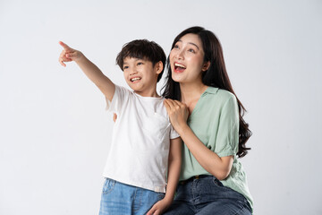 mother and son posing on a white background