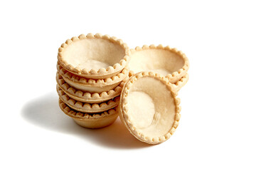 Unfilled tartlet shells isolated on white background. Stacked group of empty mini tart cups for portable desserts. Versatile tartlet bases ready for toppings