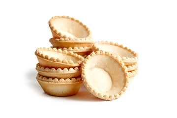 Unfilled tartlet shells isolated on white background. Stacked group of empty mini tart cups for portable desserts. Empty tartlet cups, a canvas for flavorsome combinations