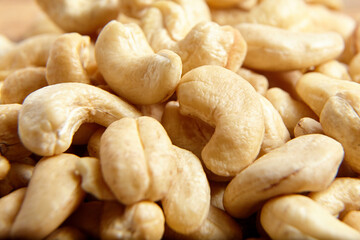 Cashew nut heap food texture background, macro shot. Raw and fresh cashews
