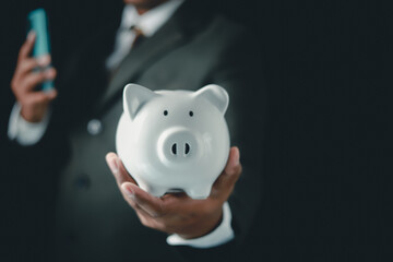 Businessman holding white medium pig piggy bank To save money, bank deposit of savings business...