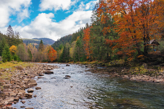 river flows through countryside valley. mountainous landscape in autumn