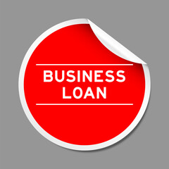Red color peel sticker label with word business loan on gray background