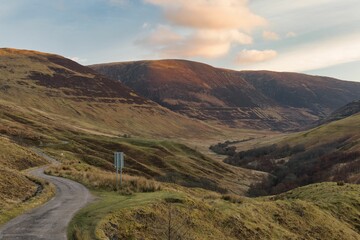 Scenic view of winding roads leading through the Glen Roy Valley in Scotland vanish at sunset