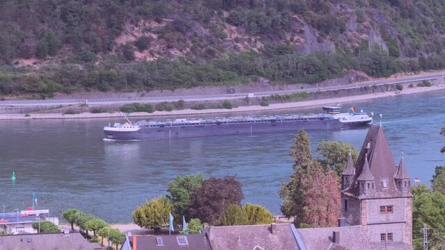 Ferry cruising, white tourist ship Rhine star on river rhine in valley among luxurious vineyards in Germany in Rhineland-Palatinate, wine tourism, romantic cruise, Bacharach, Germany - June 17, 2023