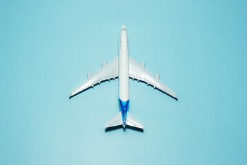 A plane miniature and isolated on blue background, after some edits.