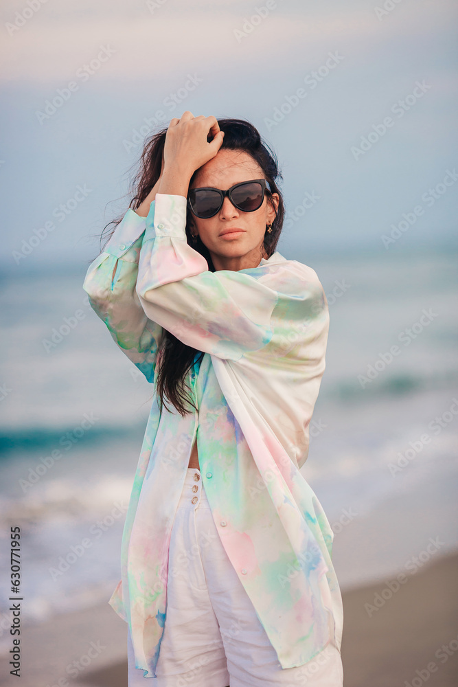 Wall mural young beautiful woman on beach vacation on caribs