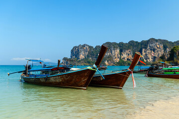 Fototapeta na wymiar Longtail tourist boats anchored on the beach in Thailand