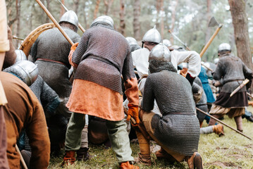 Back view of defending medieval warriors in the forest
