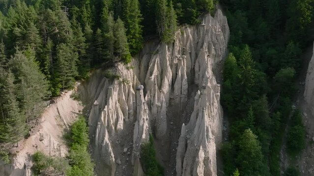 Aerial Drone shot over the Earth pyramids of Platten in South Tyrol in Alps near to Bruneck or Brunico, Bolzano, Italia