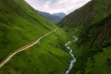 Kazbegi region, Georgia, picturesque mountain landscape wiht Chauhi River and Caucasus mountain range, Juta valley. High quality photo