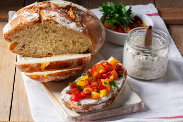 Bruschetta from homemade bread with cottage cheese and sprat pate and tomatoes on a wooden...
