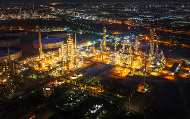 Fototapeta na wymiar Aerial view of the petrochemical, oil and gas industry. Industrial field, oil refinery storage tanks and steel pipelines at night, ecology and health.