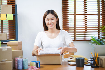 Business From Home Asian woman preparing package delivery box Shipping for shopping online. young start up small business owner at home online order