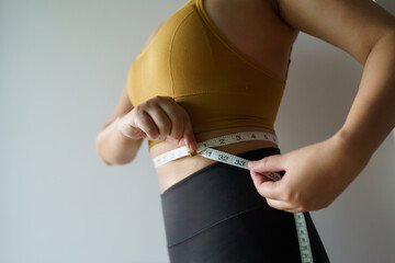 woman want to lose weight with a centimeter Shape up healthy stomach muscle and diet measuring...