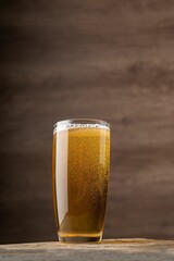 Glass of beer sitting on a wooden table in a pub setting