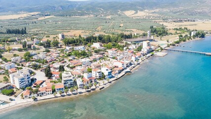 Fototapeta na wymiar Aerial view of houses on the coastline against the sea on a sunny day