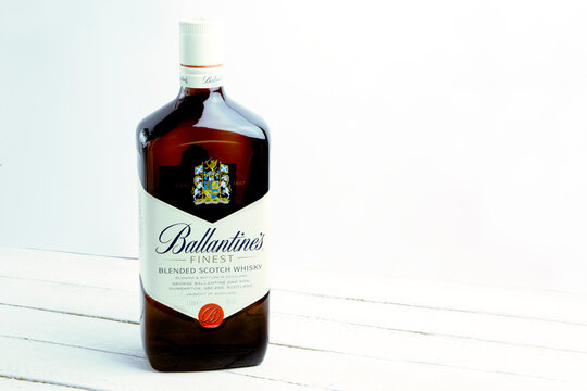 Lviv / Ukraine - 06.09.2020 : A bottle of Ballantine's finest blended scotch whisky on white wooden table, with place for text