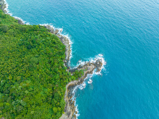 .aerial top view amazing freedom beach small white sand beach with perfect nature. .white wave hit the rock around island. .green forest peaceful. green sea, and clear sand landscape. Paradise beach..