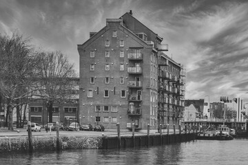 a black and white photo of an old building by the water