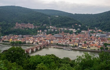 Fototapeta na wymiar Scenic cityscape of Heidelberg with green mountains. Germany.