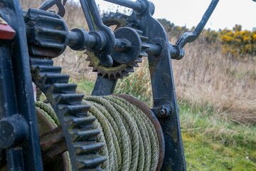 Old rope winch machine with large cogwheels