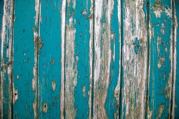 Fototapeta na wymiar Peeling paint on an old wooden fence