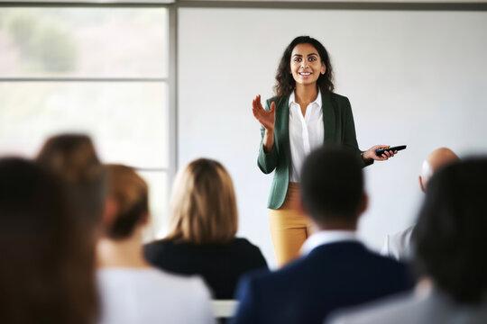A confident female executive masterfully delivers a business presentation in a boardroom, engaging her audience during an informative workshop