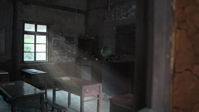 Inside of an old rustic classroom interior with wooden tables and chairs