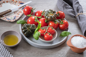 Selection of fresh tomatoes on a grey plate with napkin