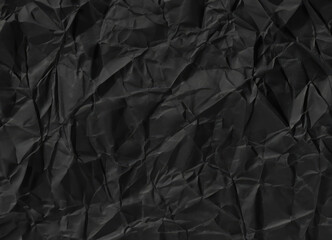 A crumpled black paper sheet, dark texture, useful as overlay or backdrop.
