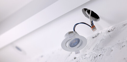 recessed lamp installation in drywall ceiling. led interior lighting. banner with copy space