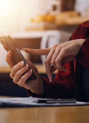 Cropped photo of Freelancer business Asian woman holding coffee cup and at doing planning analyzing the financial report, business plan investment, finance analysis the workplace.