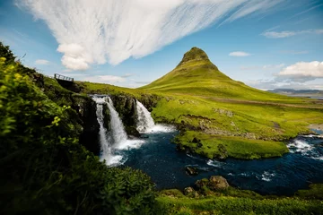 Foto auf Acrylglas Kirkjufell Tranquil Kirkjufell waterfall cascading surrounded by lush mountain terrain in Iceland